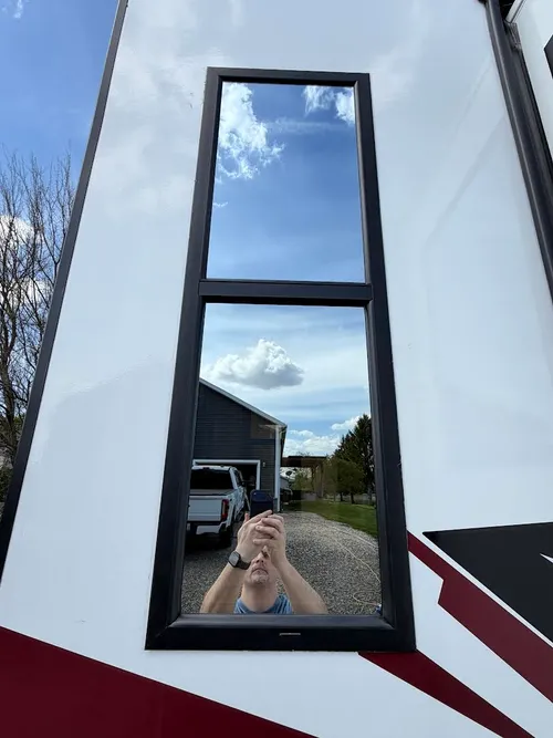 Window viewed from outside showing clearly reflective mirrored surface